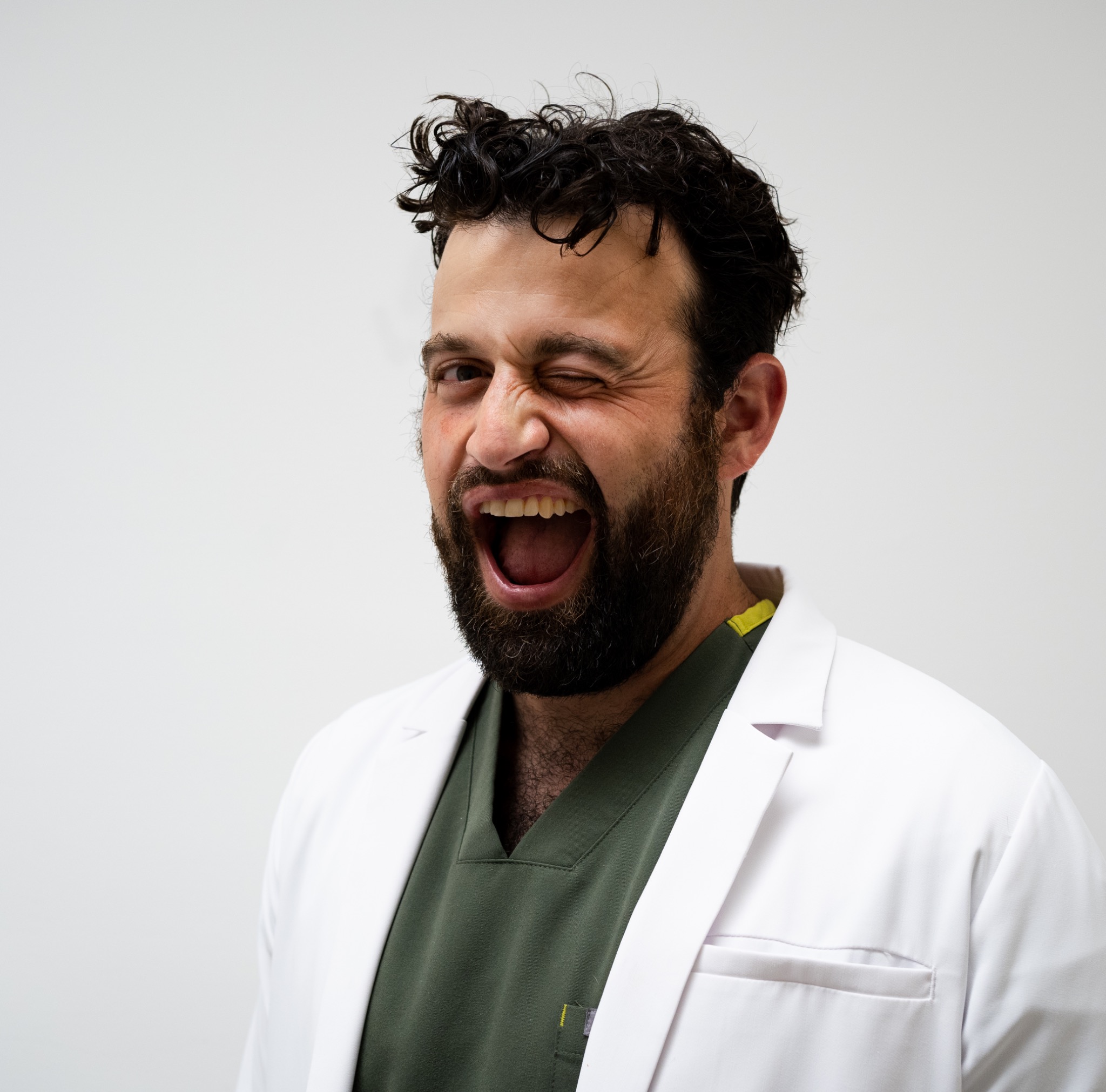 Ben laughing and winking during a portrait session