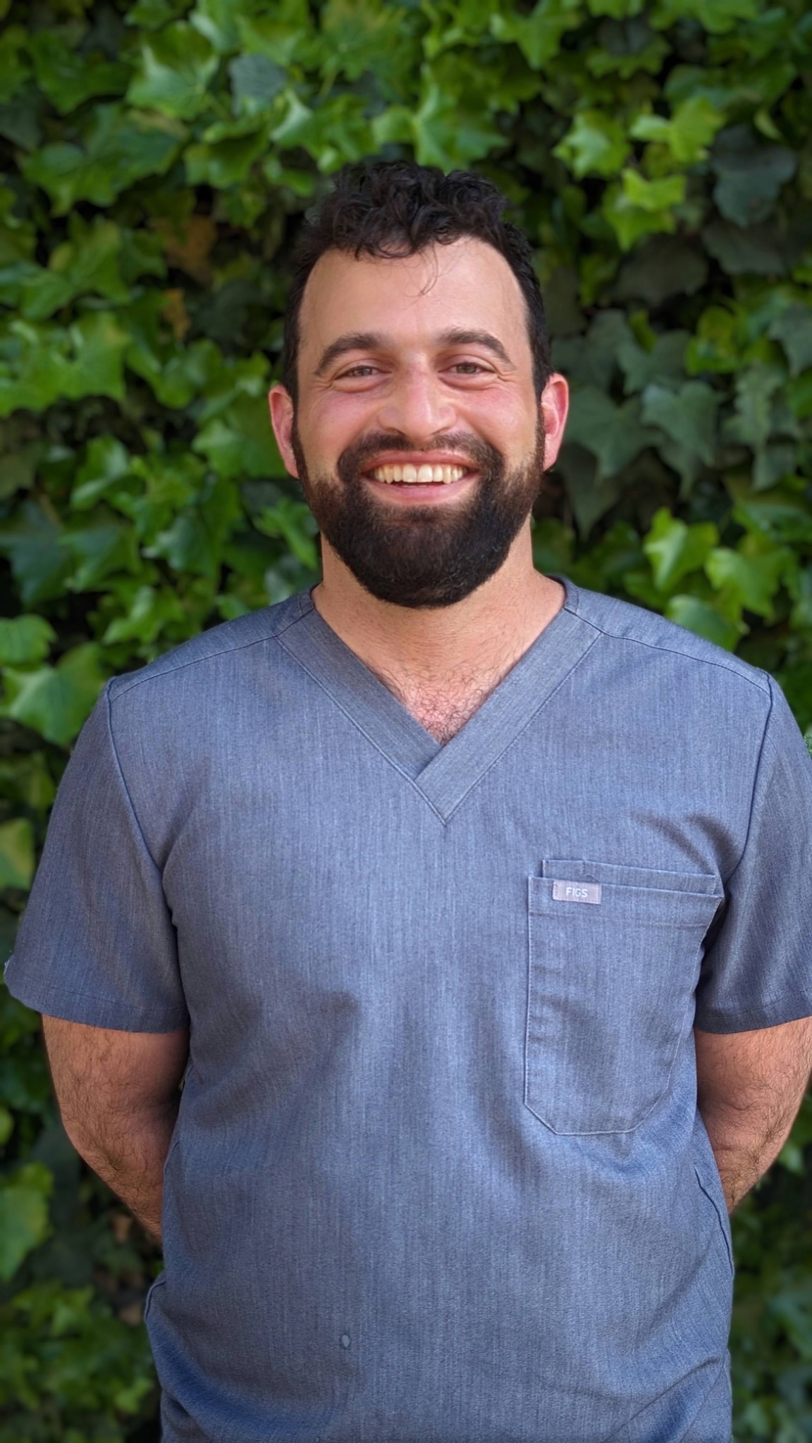 Benjamin Leventer in blue scrubs, outdoors